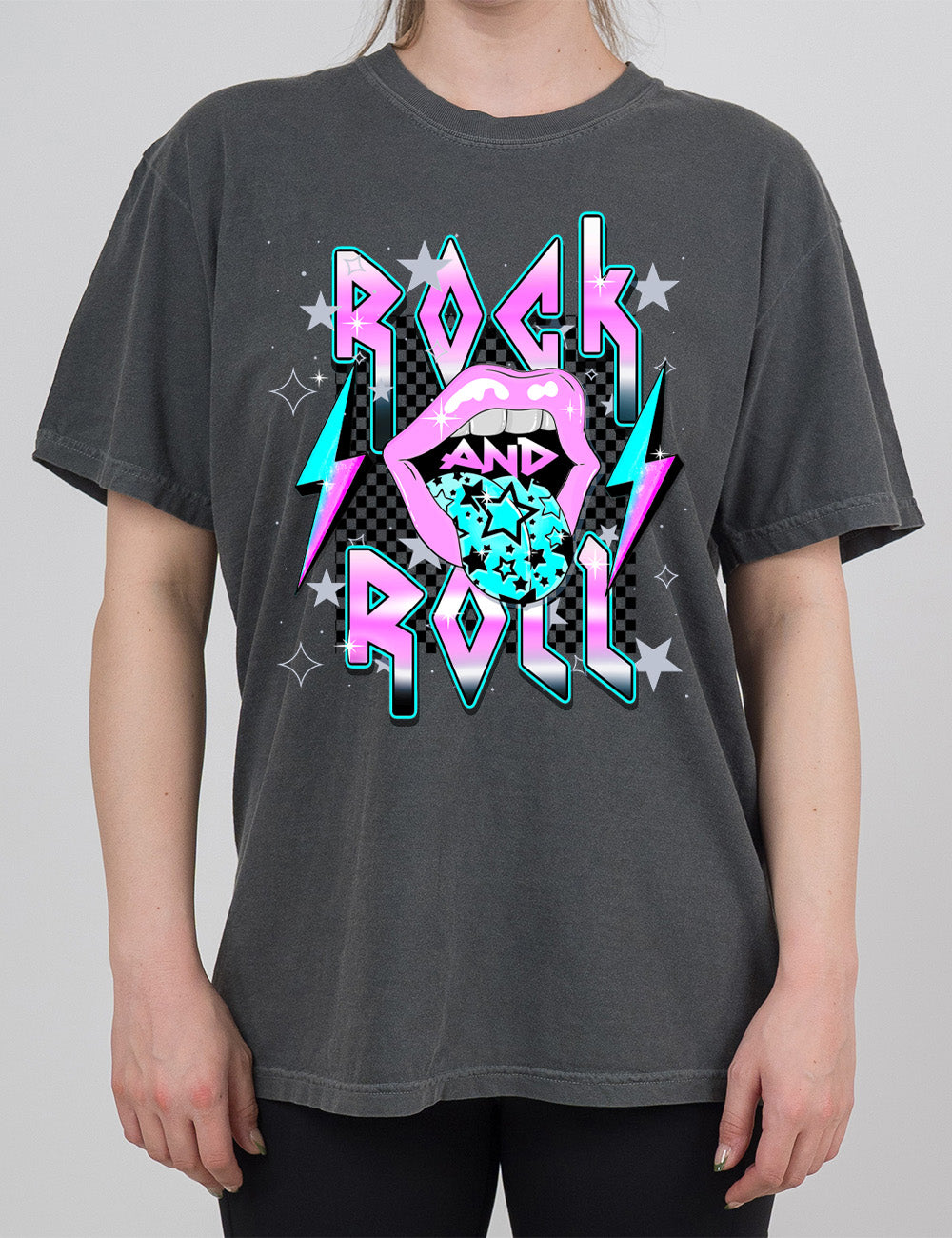 pepper modern tee with print placement on the front, with the words "rock and roll" on it, with the word "and" within the large graphic of a mouth, with it's tongue sticking out with stars on it, and a number of stars around the words, with a lightning bolt on both sides of the mouth