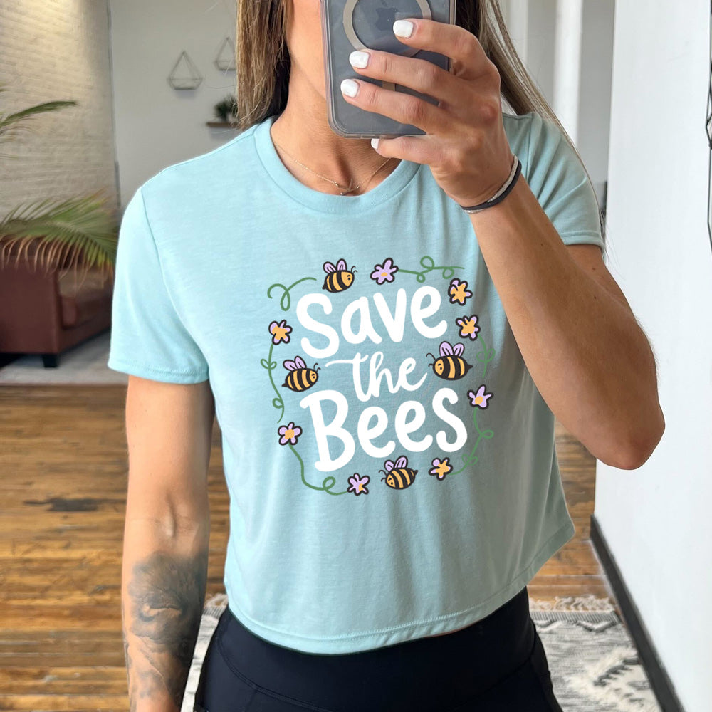 dusty blue cropped tee with a bees and flowers graphic on it that says "Save The Bees" 