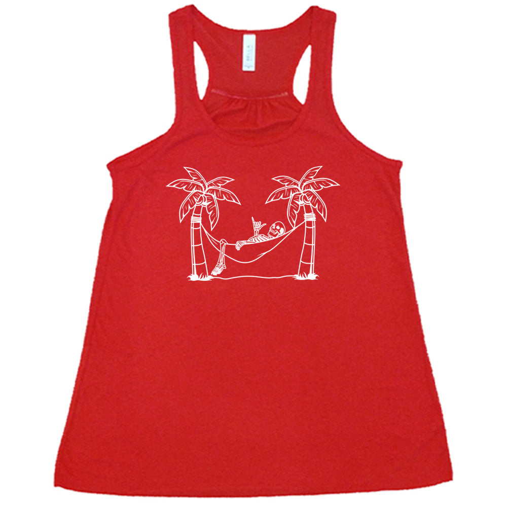 Red colored flowy tank with a skeleton on a hammock graphic on it