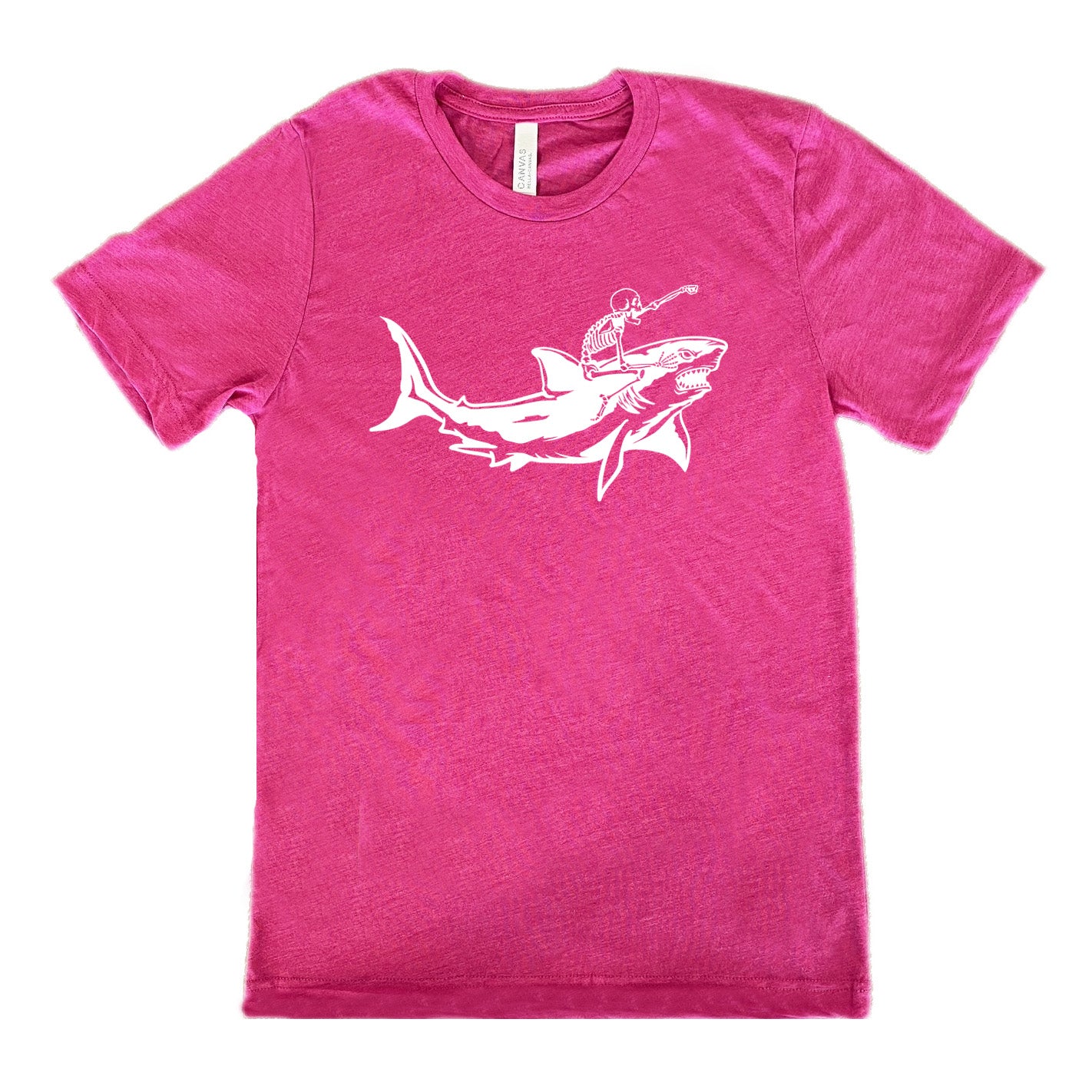 berry unisex tee with the graphic of a skeleton, with its fist pointing onwards and its mouth open, riding a shark, who has a fierce expression