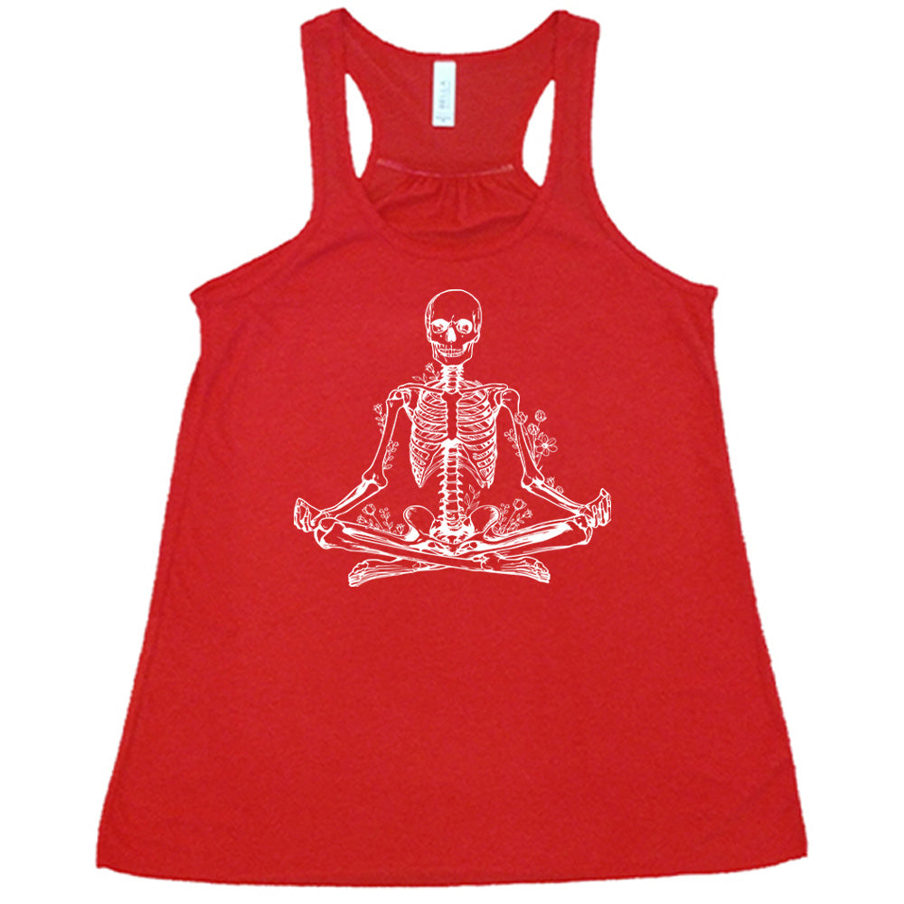 Red flowy tank with a graphic of a skeleton doing a yoga pose, with some flowers growing out of different place on the body