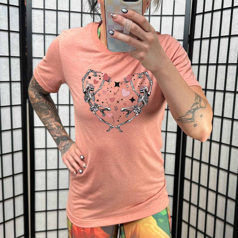 coral shirt with a skeleton heart graphic on it