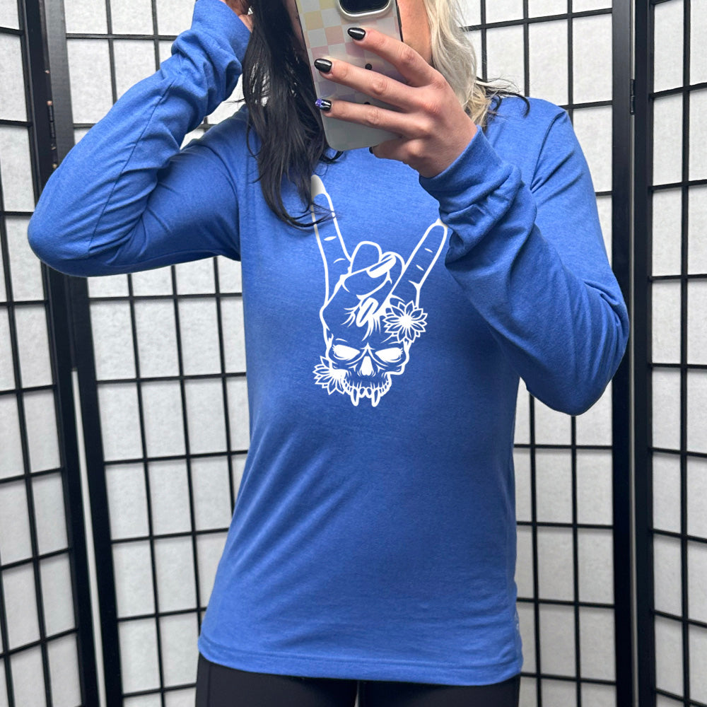heather true royal long sleeve shirt with the graphic of a skull whose head is a rocker hand symbol