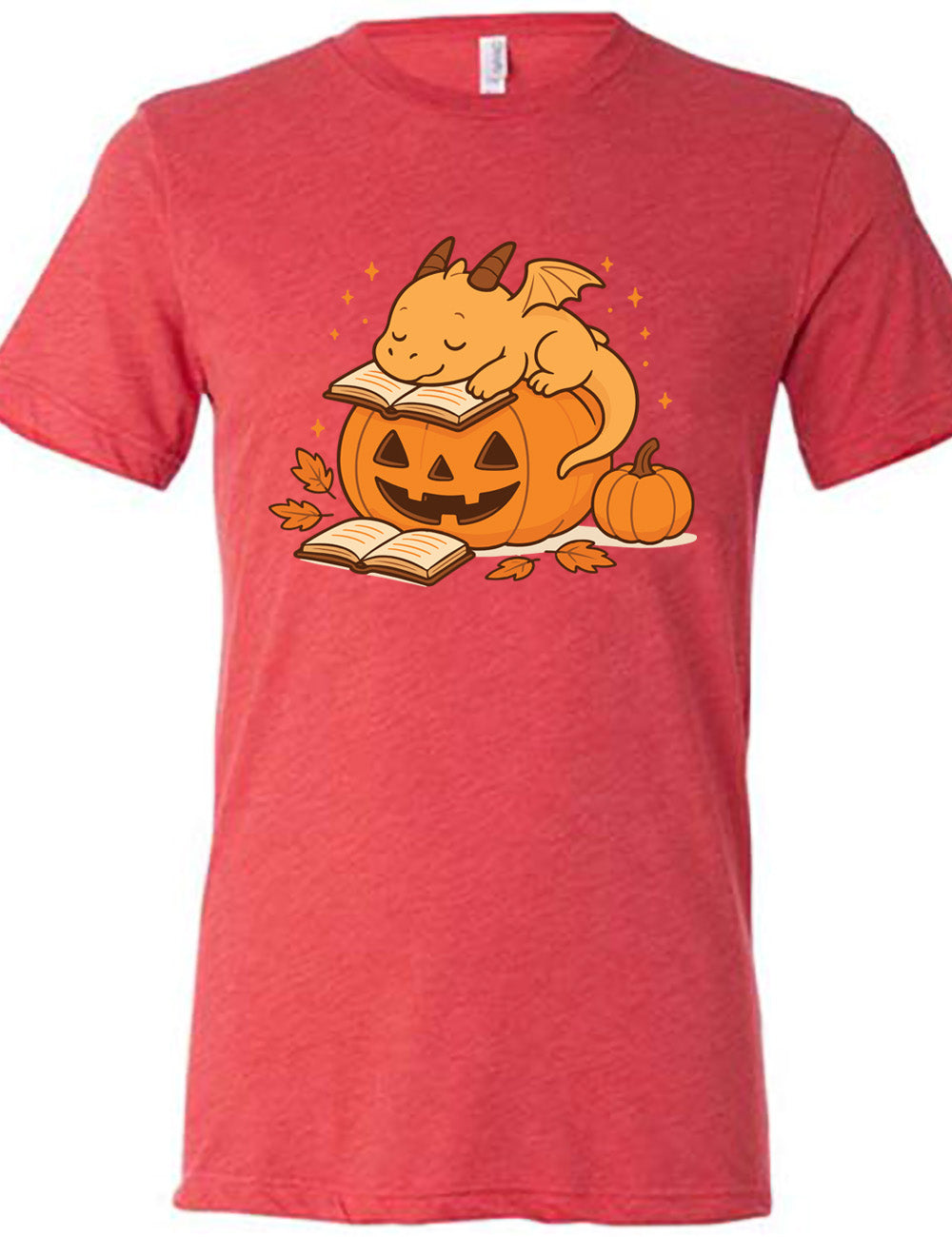 red unisex tee with the graphic of a cartoon-style dragon sleeping, with its head in its open book, on top of a jack-o-lantern, with another open book and small pumpkin next to all this, and a scattering of stars, and a few leaves