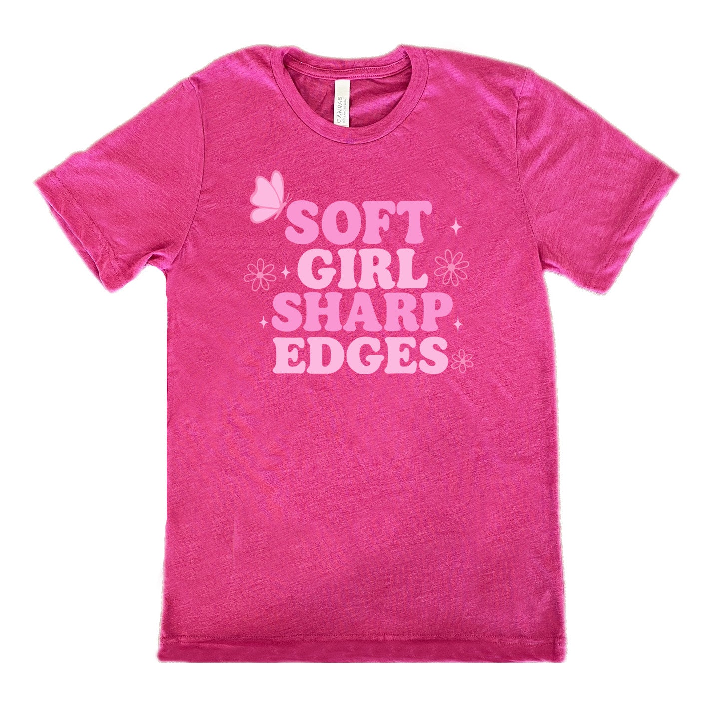 berry unisex tee with the words "soft girl sharp edges" in all caps, with graphics of a few little flowers and stars and one butterfly 