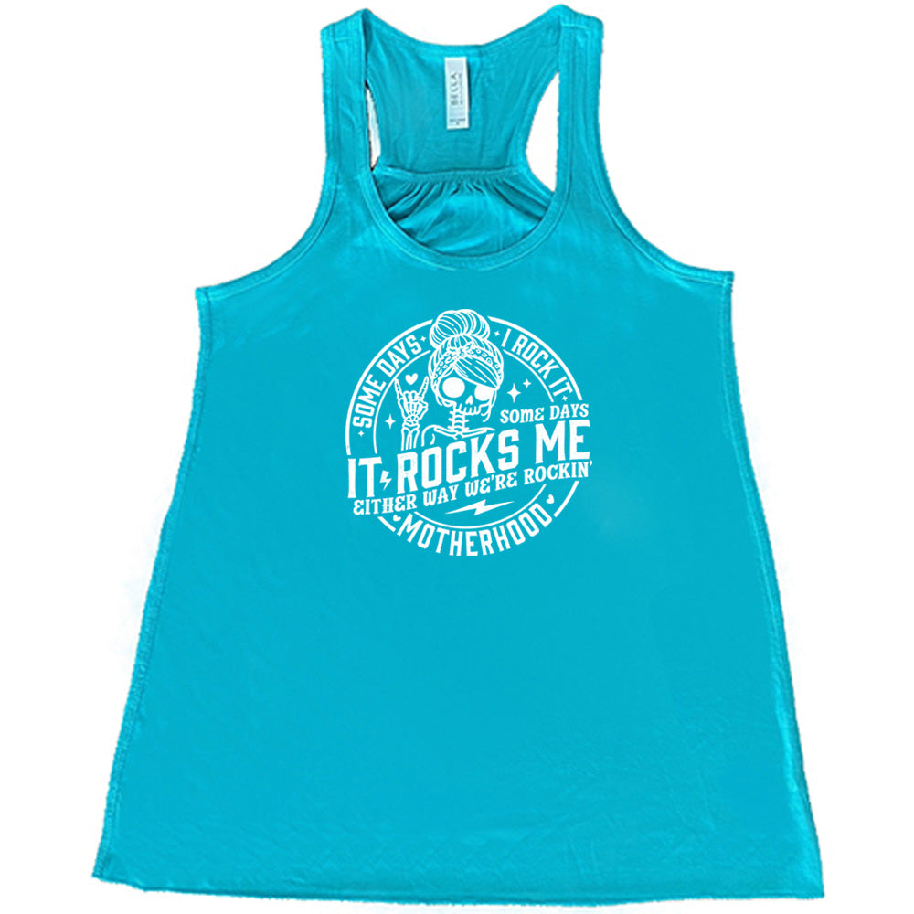 Teal colored flowy tank with a female skeleton graphic on it that says "Some Days I Rock It Some Days It Rocks Me" 