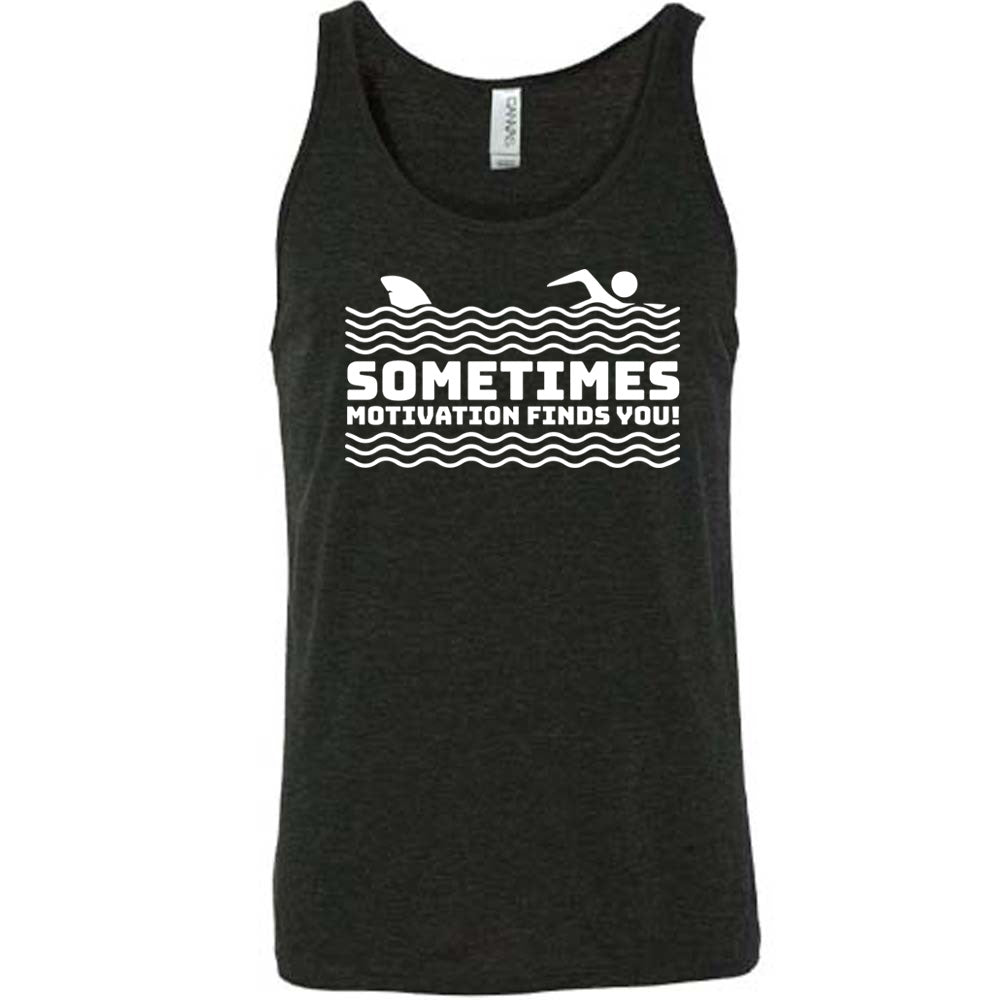 black unisex tank with the words "sometimes motivation finds you!" in between the lined graphic of waves of the sea, and on top of the waves is the graphic of a figure swimming away from a fin in the water behind