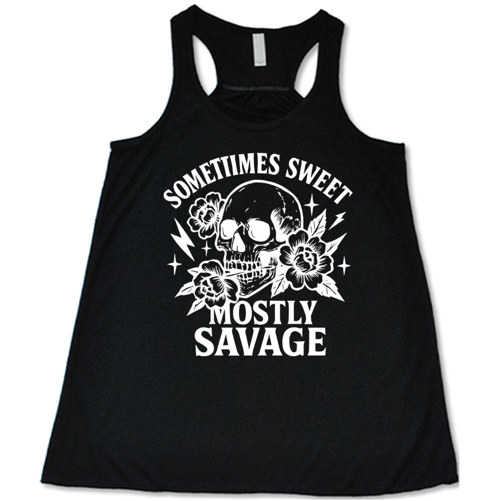 black flowy tank with the words "sometimes sweet mostly savage on it with the graphic of a skull holding a flower between its teeth, with a couple flowers and a few stars and lightening bolts around it
