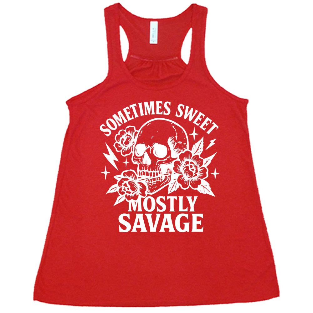 red flowy tank with the words "sometimes sweet mostly savage on it with the graphic of a skull holding a flower between its teeth, with a couple flowers and a few stars and lightening bolts around it