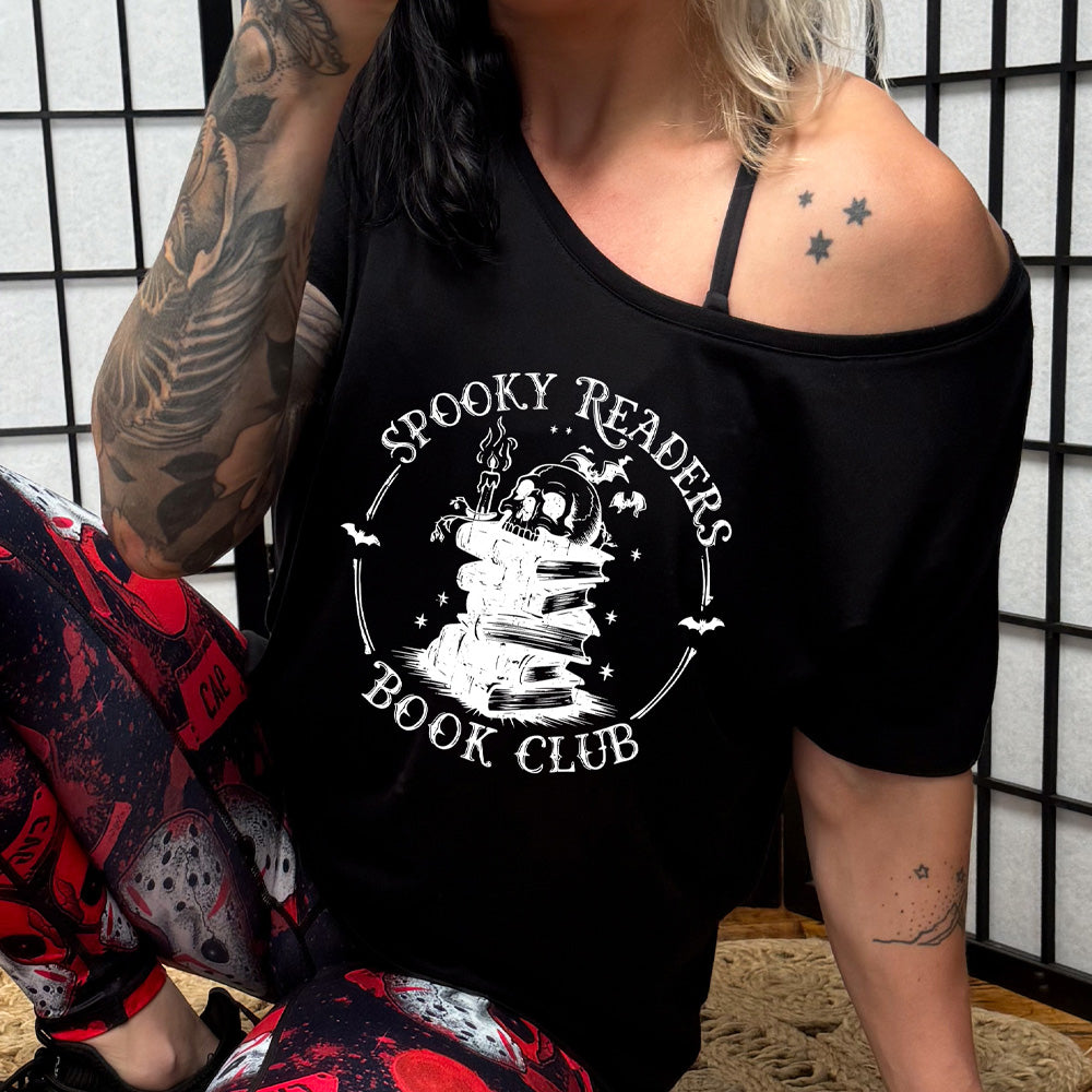shirt with skull on a stack of books graphic on it that says "Spooky Readers Book Club"