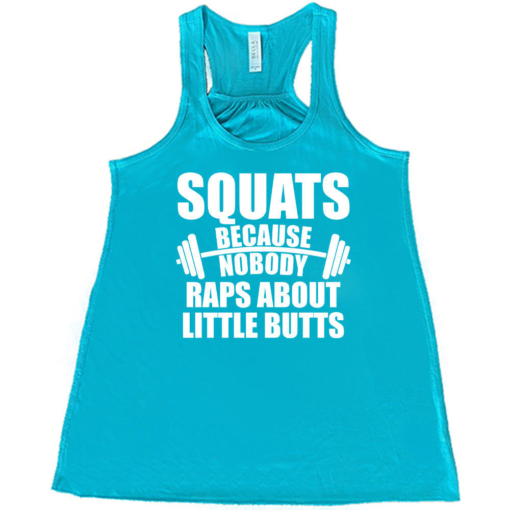 teal flowy tank with the words "squats because nobody raps about little butts" in all caps with a graphic of a barbell between the words "because" and "nobody"