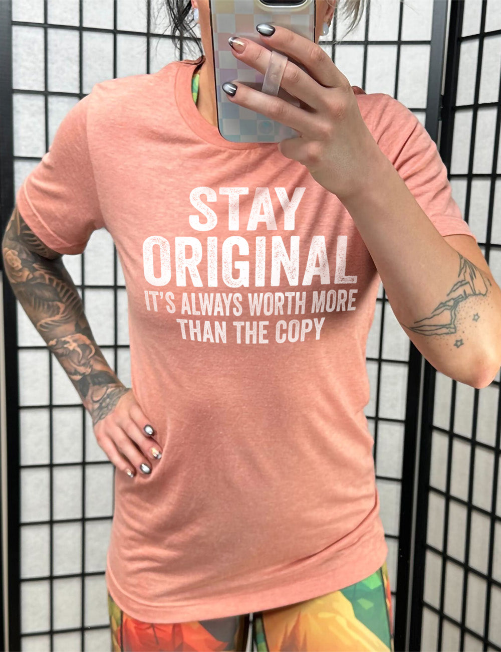 sunset unisex tee with the large wording saying "stay original" followed by smaller wording saying "it's always worth more than the copy"