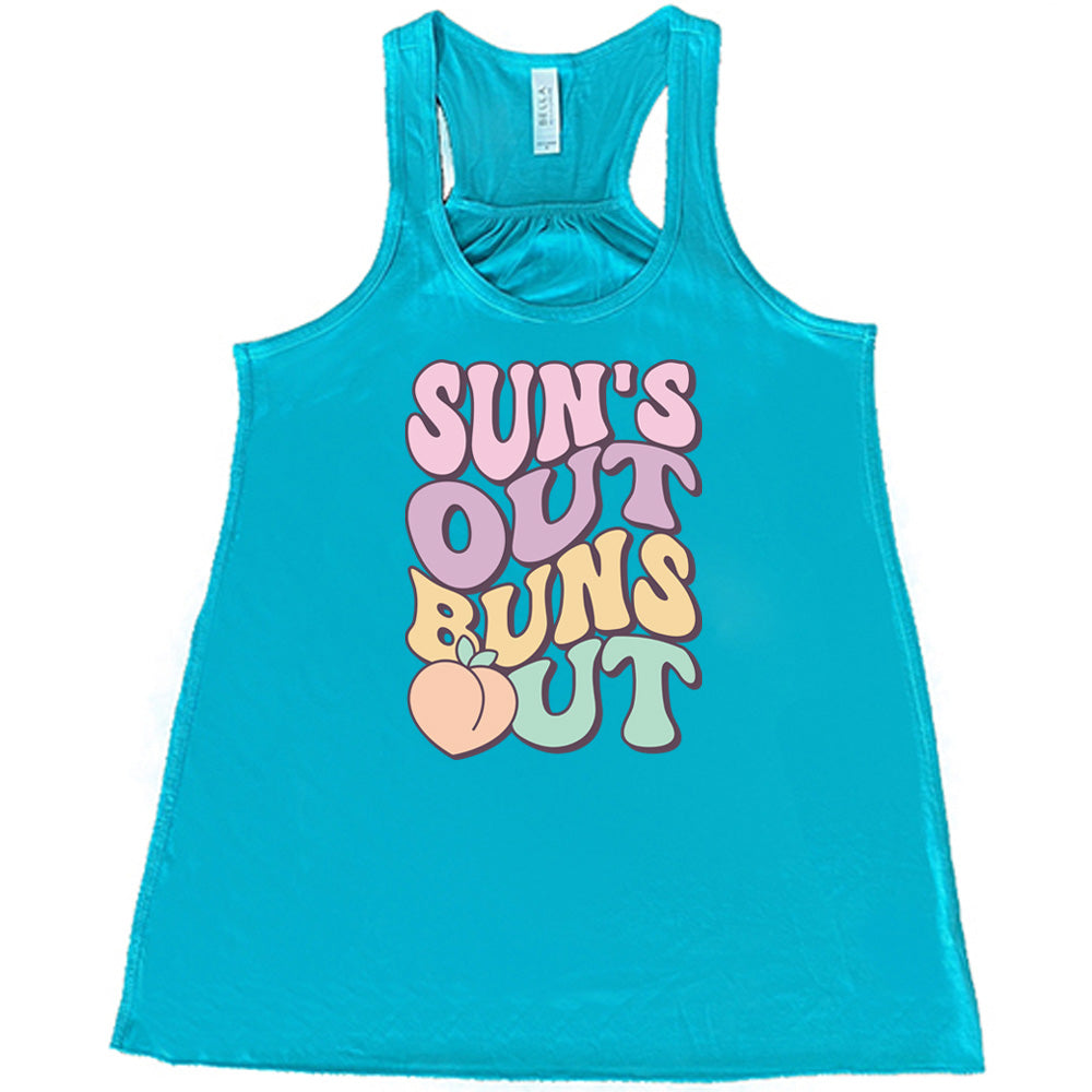 Teal colored flowy tank with a peach graphic on it that says "Suns Out Buns Out" 