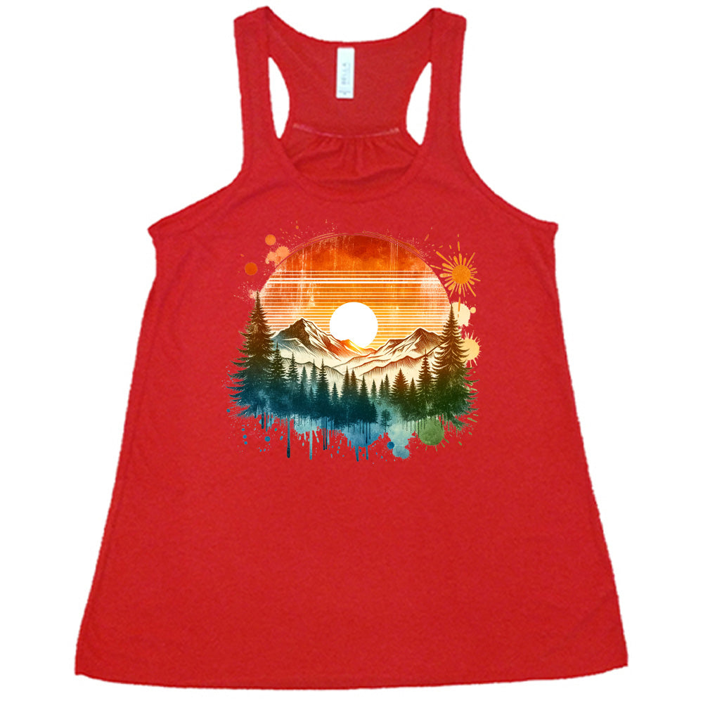 Red colored flowy tank with a sunset-mountain landscape graphic on it