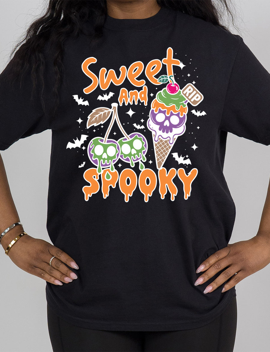 black modern tee with the graphic of two cherries on the same branch, with a skull dripping on each of them, and a cherry-topped ice cream cone, with one of the scoops being a skull, with a little "RIP" sign sticking out of the cone, surrounded by bats and stars, and the words starting on top and ending below the graphics saying "sweet and spooky"