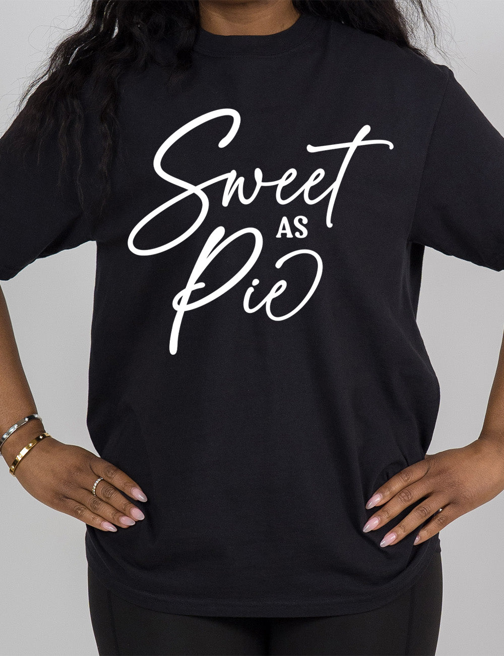black modern tee with the words, in mostly sweeping cursive, saying "sweet as pie"