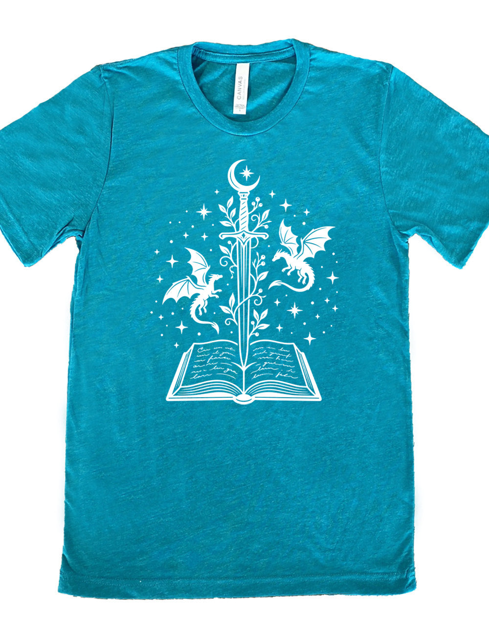teal unisex tee with the graphic of a sword, with a crescent moon on top of the handle and with a vine wrapping around it, pointing down into an open book, surrounded by stars, and a dragon flying on either side