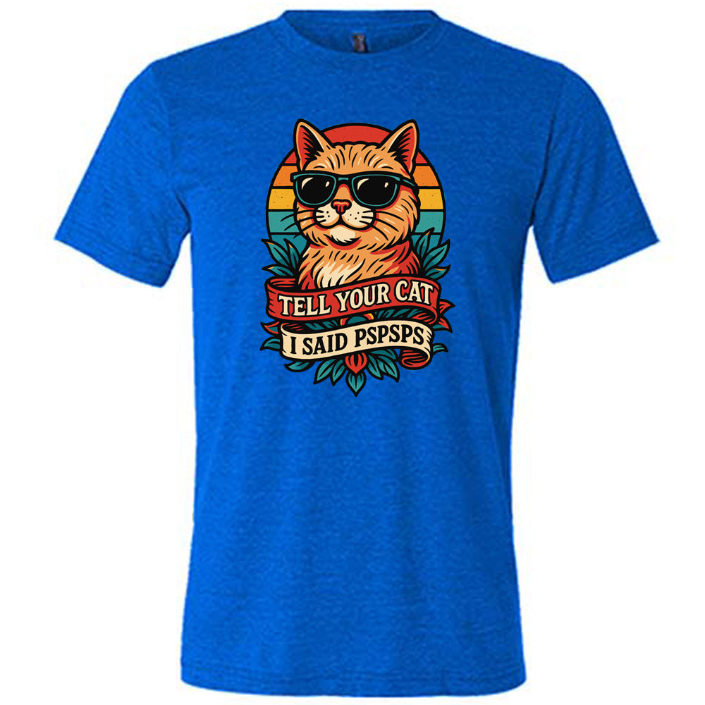 blue unisex tee with the large graphic of a cat head and torso, wearing sunglasses, with a colorful background, and two banners below it with the words "tell your cat I said pspsps" on them