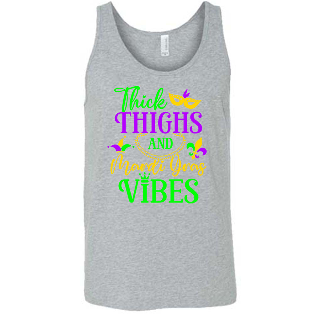 grey unisex tank with the words "thick thighs and mardi gras vibes" on it in varying font, with small graphics of mardi gras beads, fleur de lis, a joker hat and a mask