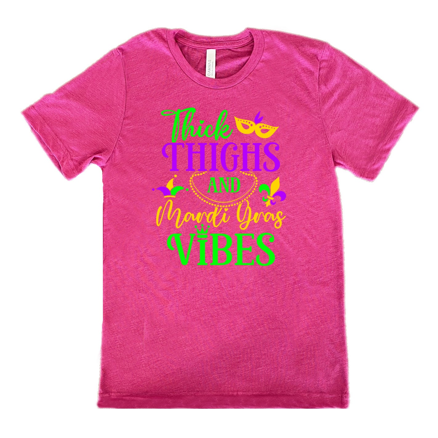 berry unisex tee with the words "thick thighs and mardi gras vibes" on it in varying font, with small graphics of mardi gras beads, fleur de lis, a joker hat and a mask