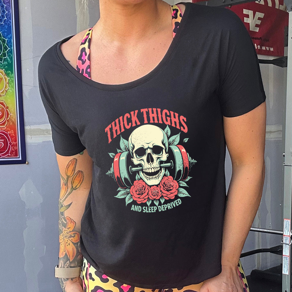 black slouchy tee with the text "Thick Thighs And Sleep Deprived" on it