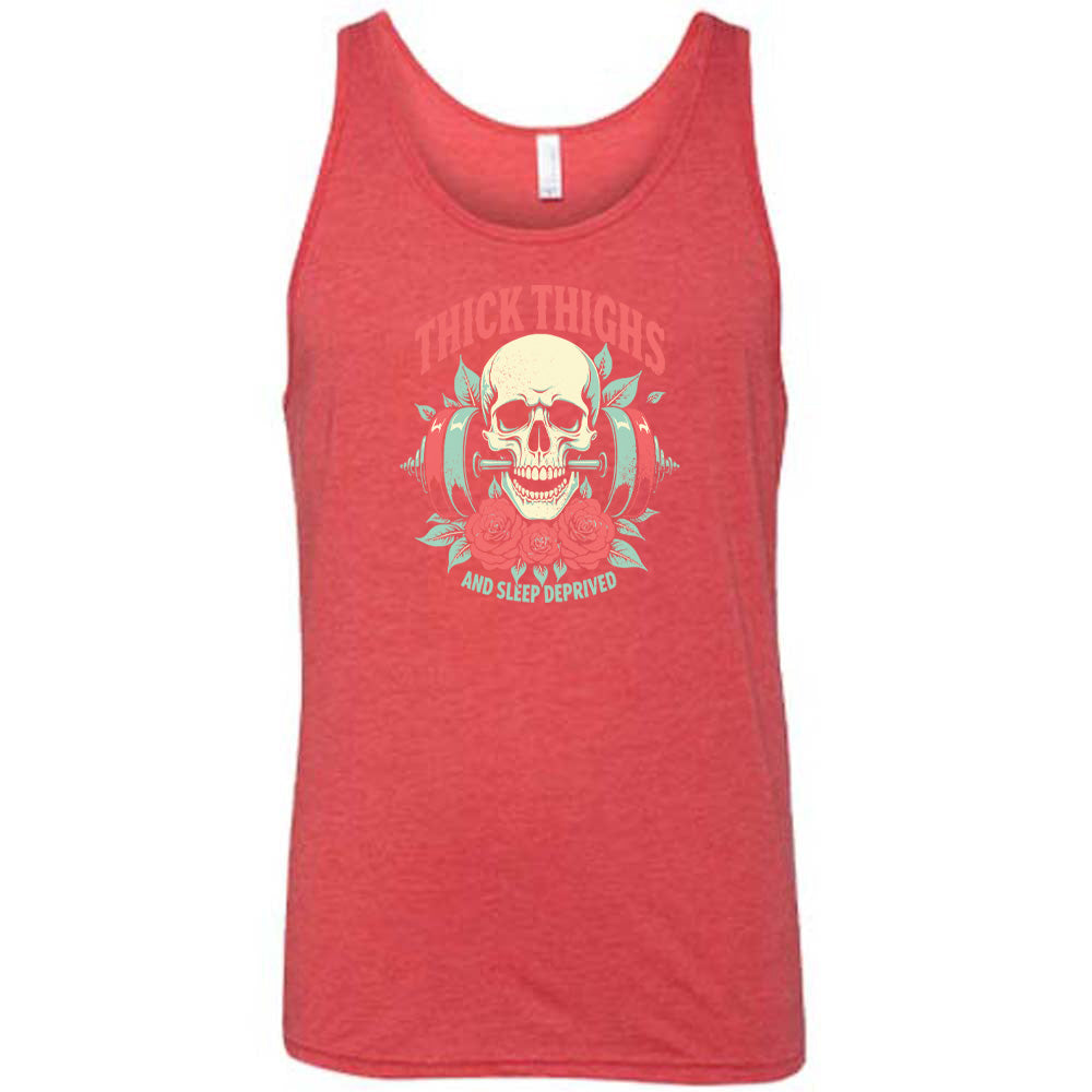 Red colored tank with a skull, flowers, and barbell graphic on it that says "Thick Thighs And Sleep Deprived" 