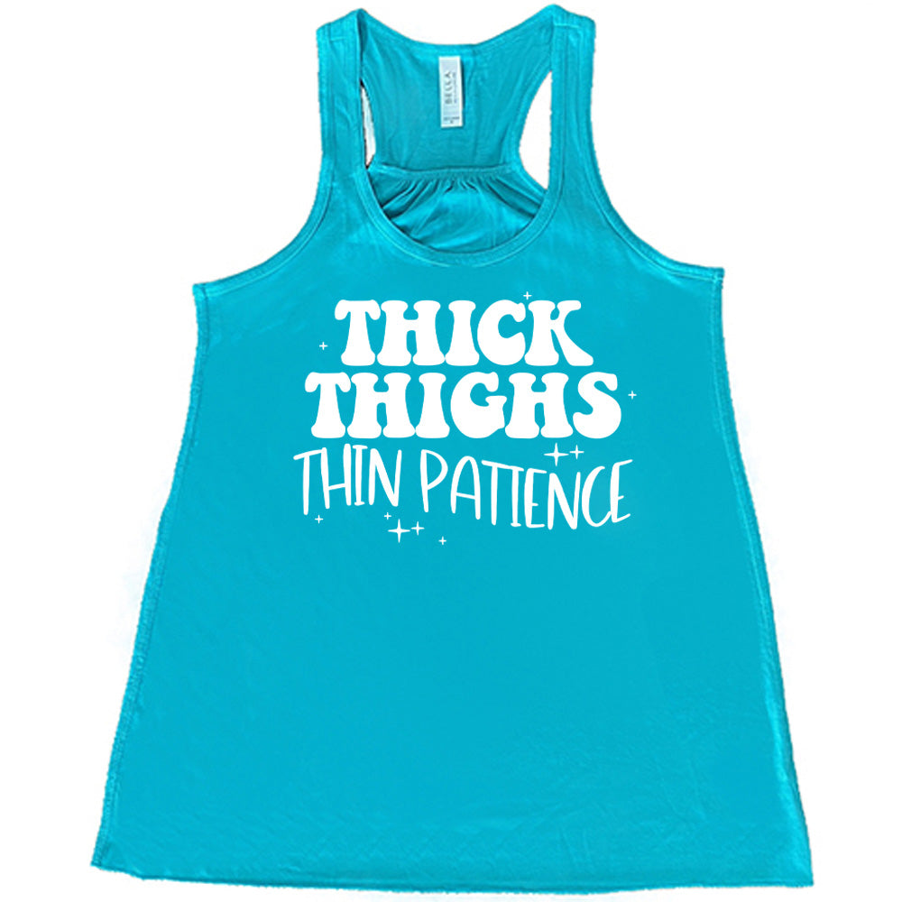 Teal Flowy Tank with Thick Thighs Thin Patience in white lettering, with little stars