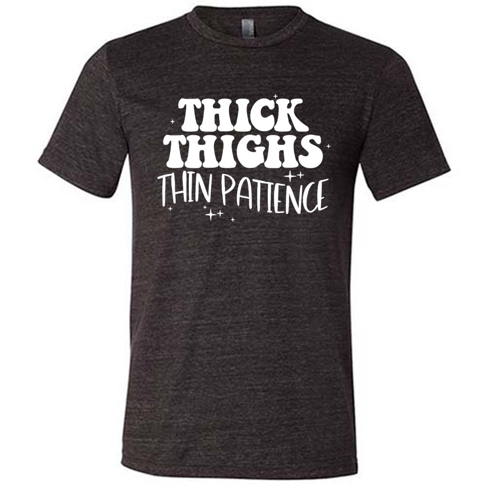 black unisex tee with the words "thick thighs thin patience" on it, with a few scattered little stars