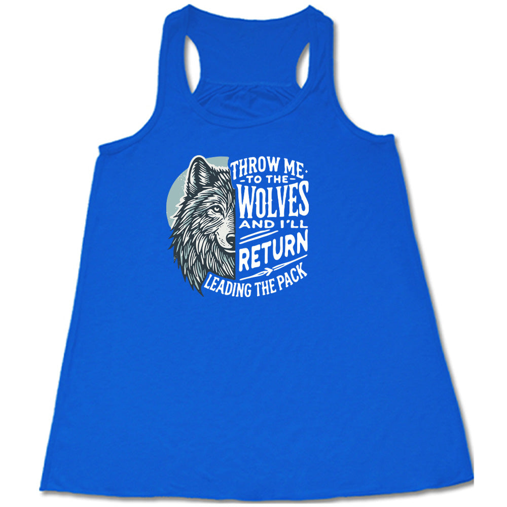 Blue colored flowy tank with a wolf face graphic on it that says "Throw Me To The Wolves And I'll Return Leading the Pack" 