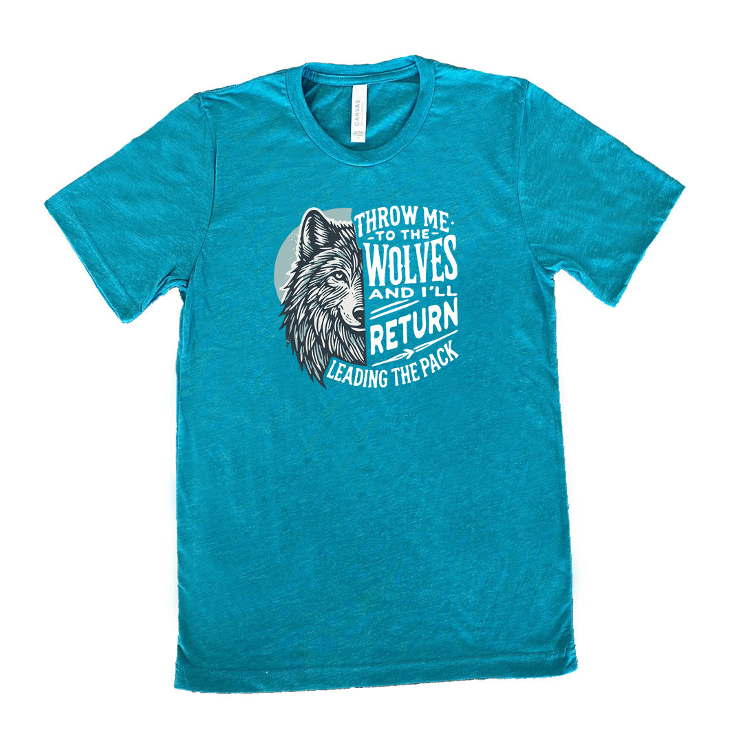 Teal colored shirt with a wolf face graphic on it that says "Throw Me To The Wolves And I'll Return Leading the Pack" 