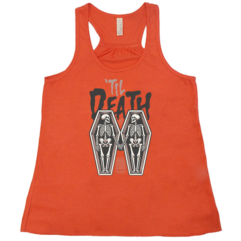 coral flowy tank with the words "'til death" on it, with graphics of two skeletons, both in their own coffins, holding hands in the middle