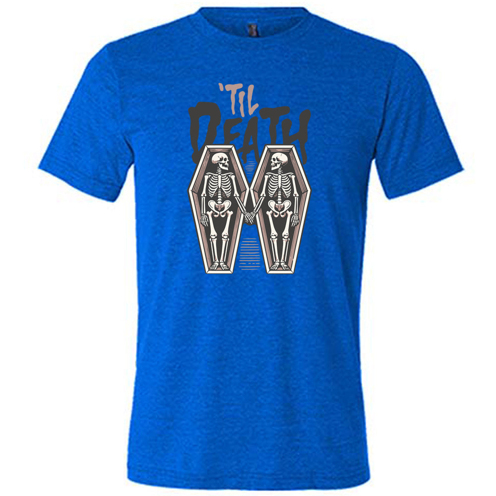 blue unisex tee with the words "'til death" on it, with graphics of two skeletons, both in their own coffins, holding hands in the middle