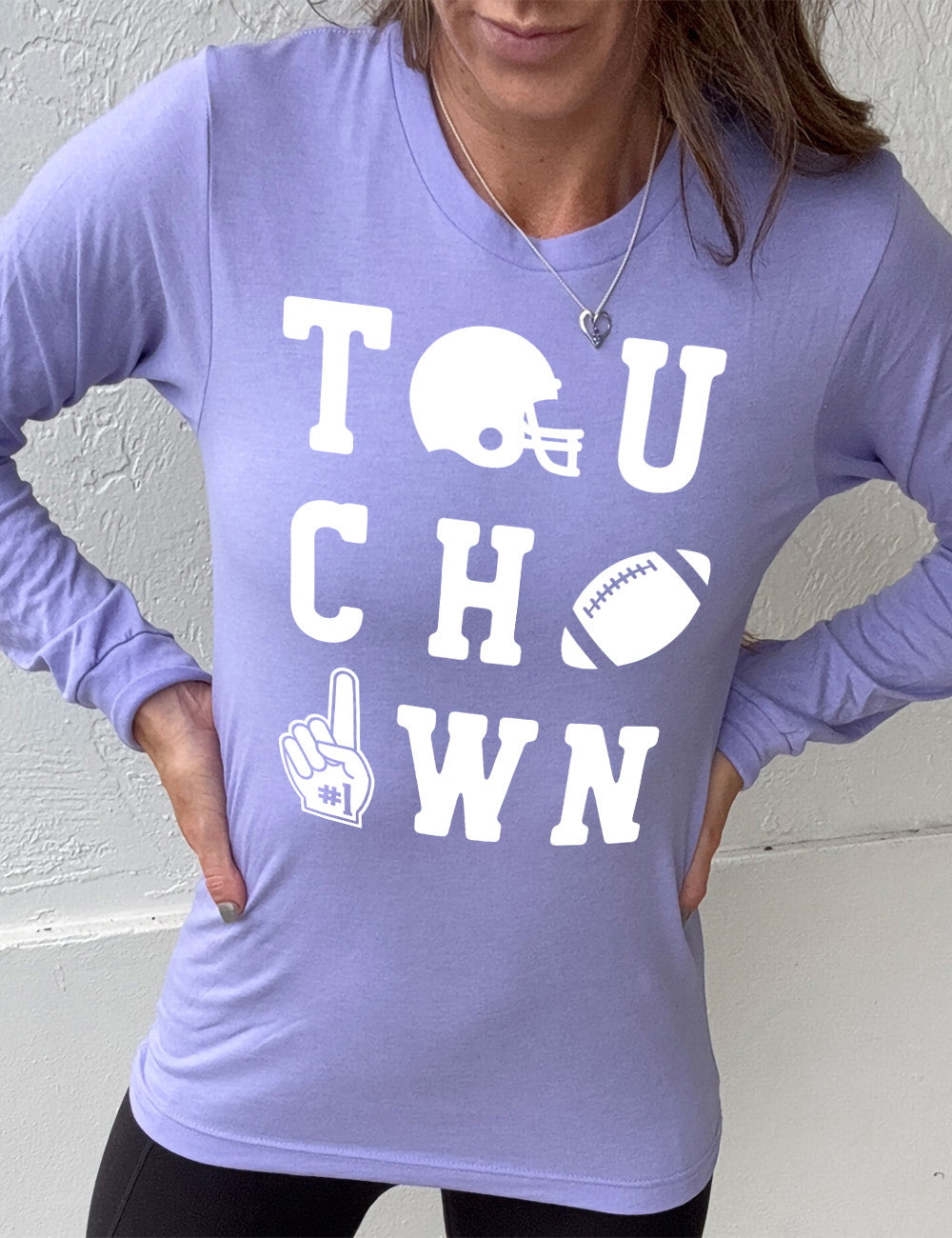 heather dark lavender long sleeve tee with the word "touchdown" spelled out over three rows, and with the first "o" being a football helmet, the "d" being a football, and the last "o" being a foam finger with #1 on it