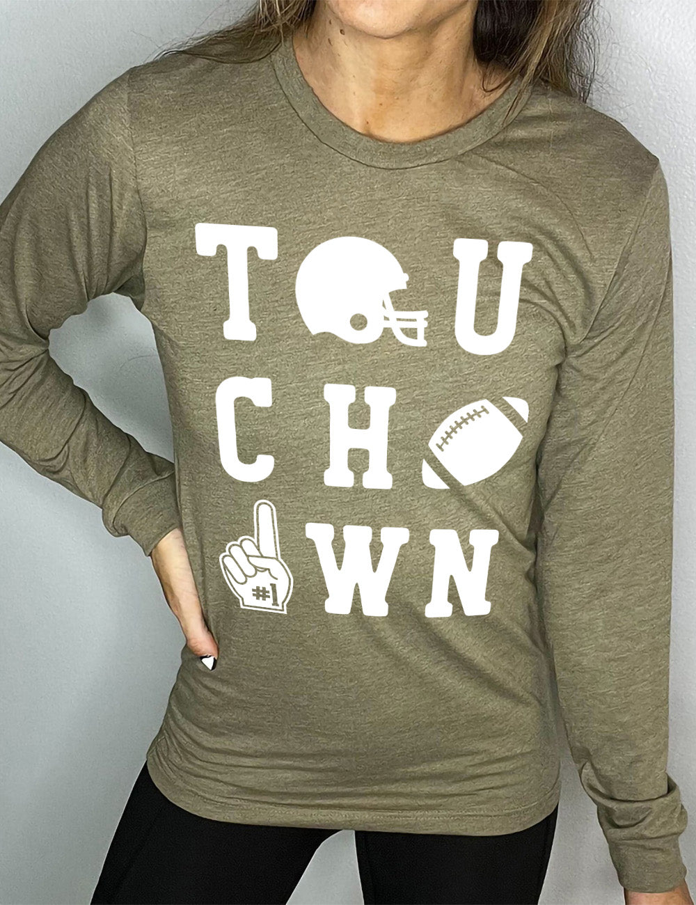 heather olive long sleeve tee with the word "touchdown" spelled out over three rows, and with the first "o" being a football helmet, the "d" being a football, and the last "o" being a foam finger with #1 on it