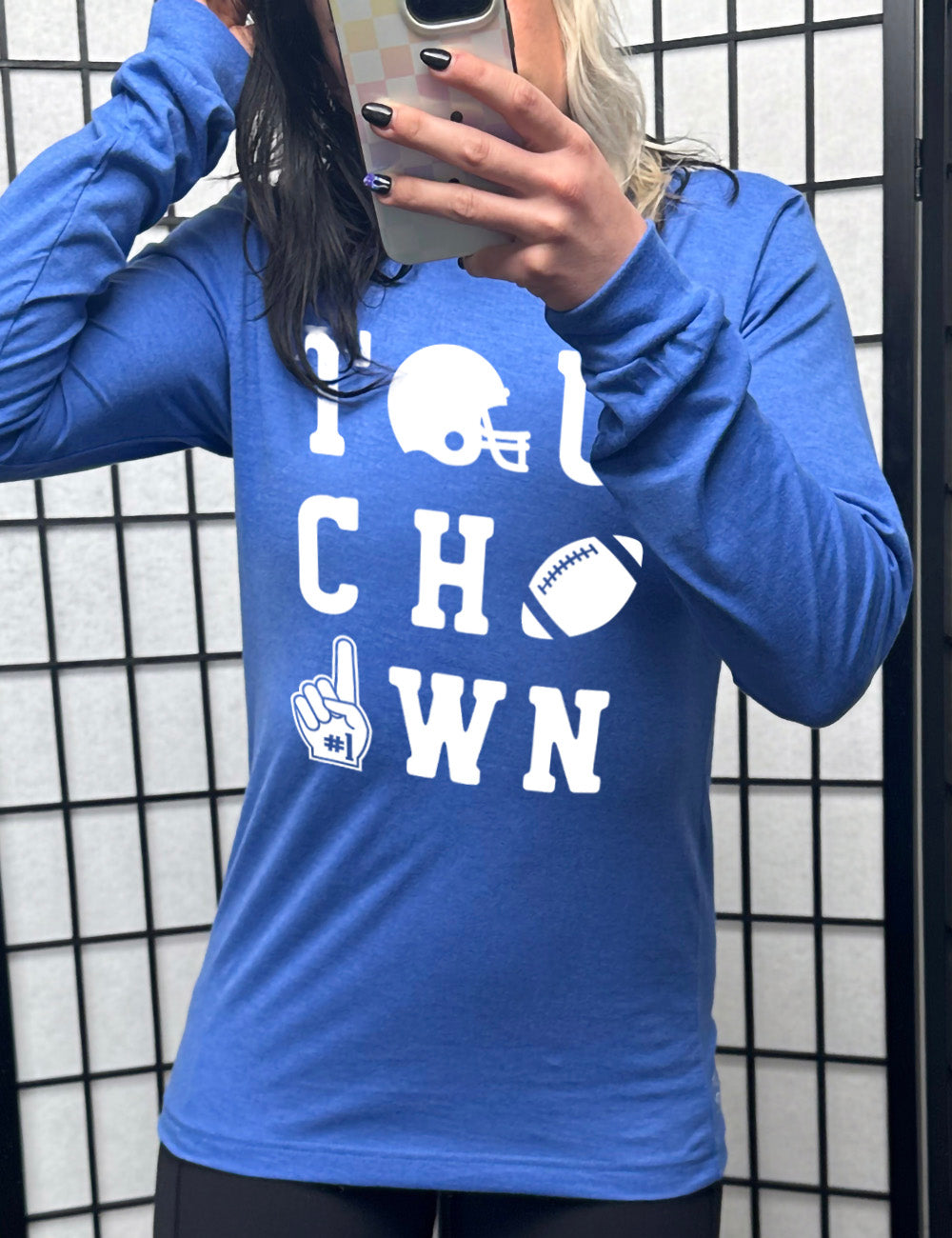 heather true royal long sleeve tee with the word "touchdown" spelled out over three rows, and with the first "o" being a football helmet, the "d" being a football, and the last "o" being a foam finger with #1 on it