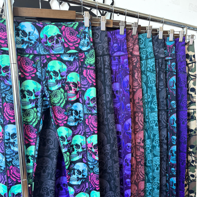 a rack with 9 skull leggings hanging on it