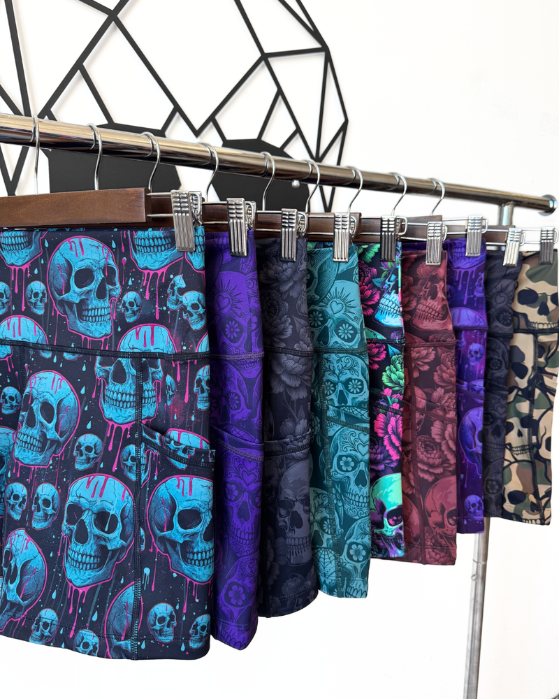 Shorts with skull patterns on a rack against a geometric black and white background