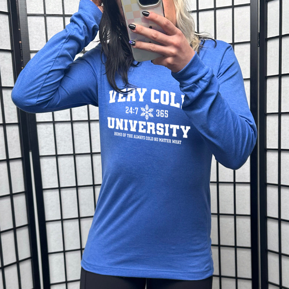 heather true royal long sleeve shirt with the words "very cold university" in big letters, with 24:7 and 365 separated by a snowflake graphic, and little words underneath it all saying "home of the always cold no matter what"