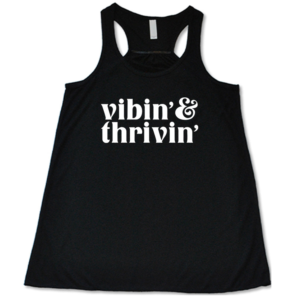 black shirt with the text "Vibin & Thrivin" on it