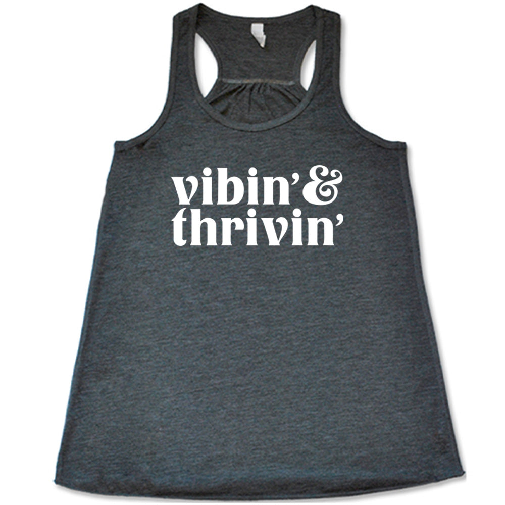 grey shirt with the text "Vibin & Thrivin" on it