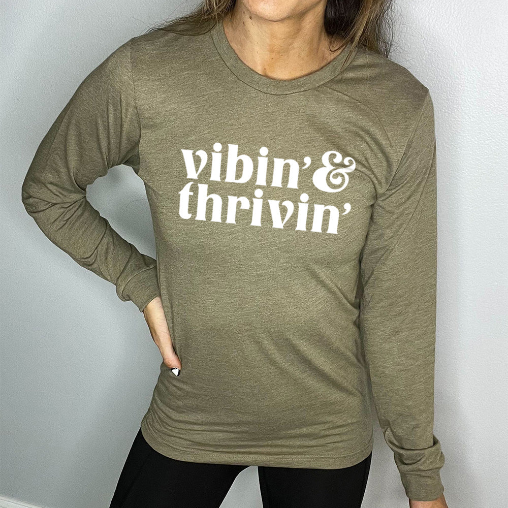 heather olive long sleeve shirt with the text "Vibin' & Thrivin'" on it