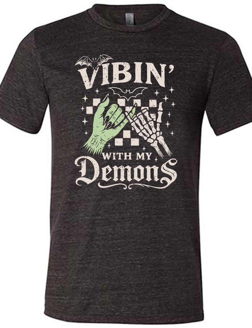 black unisex tee with words saying "Vibin' with my Demons", around the graphic of the hands of a zombie and a skeleton doing a pinky promise, in front of a checkered background, and one line-drawn bat and one detailed bat on top, and scattered stars