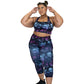 model wearing capri length purple and blue skull and butterfly leggings and matching sports bra