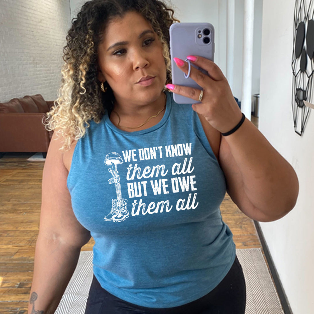 model wearing the blue "We Don't Know Them All But We Owe Them All" Muscle Tank