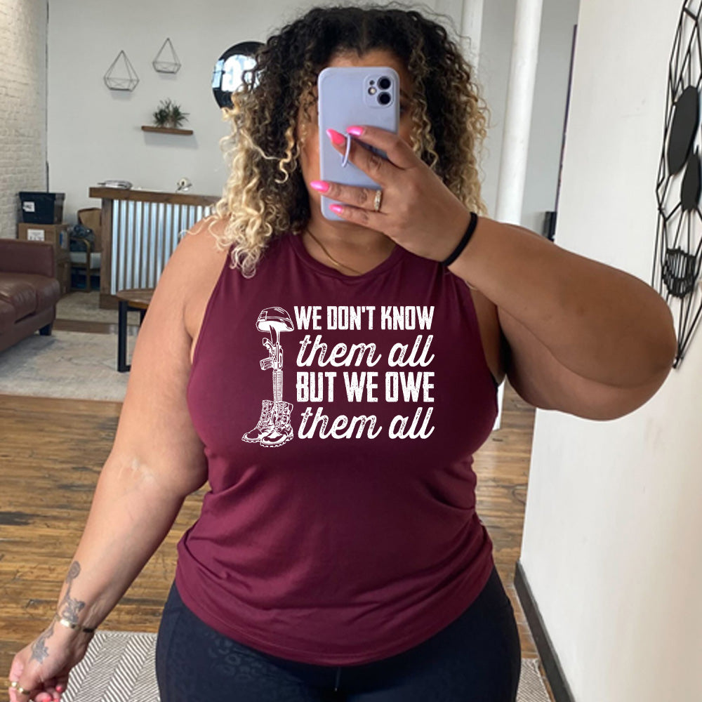 model wearing the maroon "We Don't Know Them All But We Owe Them All" Muscle Tank