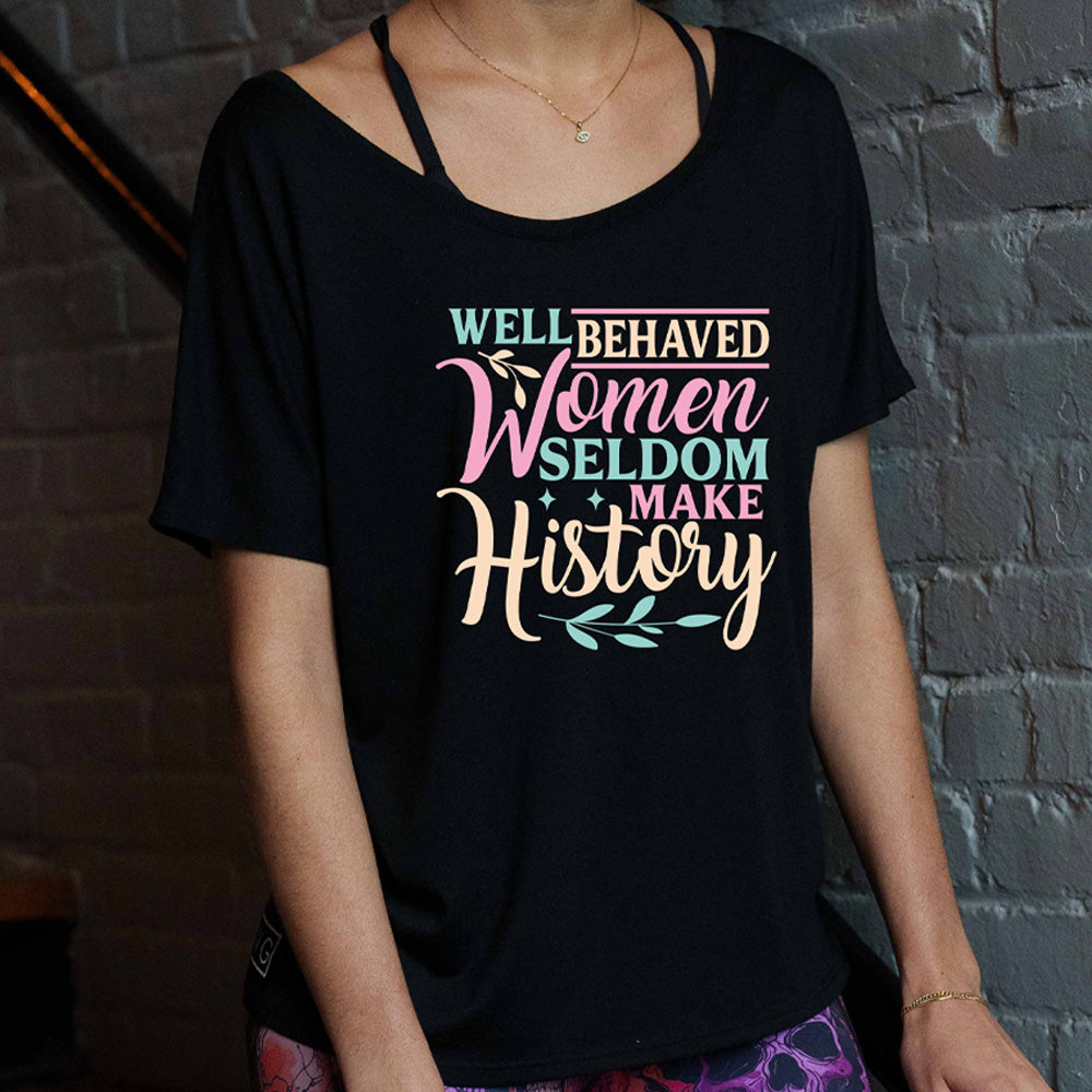 black slouchy tee with the words "well behaved women seldom make history" with graphics of small branches and a couple little stars