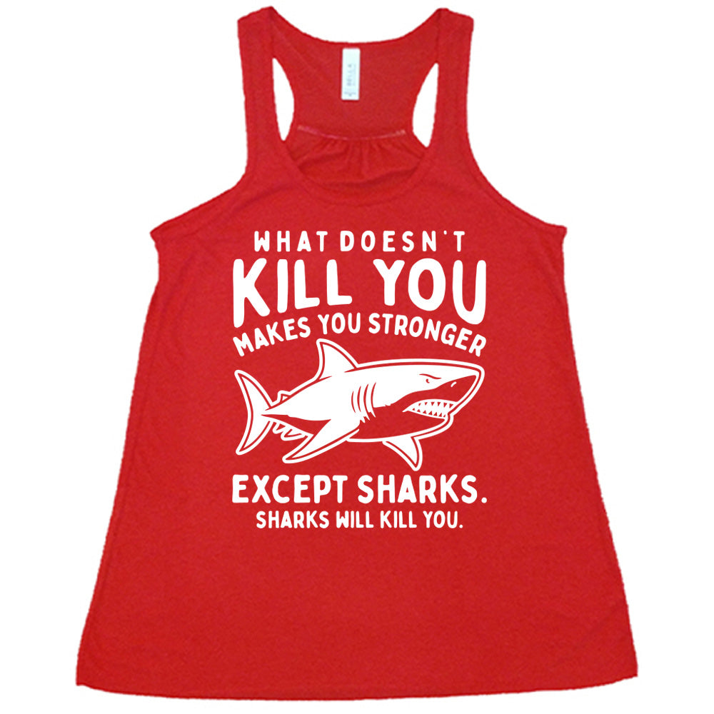 red racerback flowy tank with the words "what doesn't kill you makes you stronger except sharks. sharks will kill you." and the graphic of a fierce shark in the middle