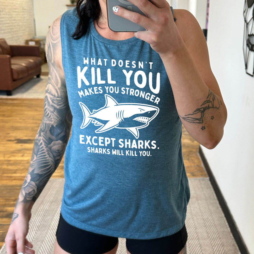 deep teal muscle tank with the words "what doesn't kill you makes you stronger except sharks. sharks will kill you." and the graphic of a fierce shark in the middle
