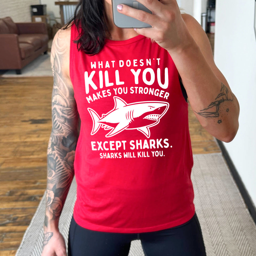 red muscle tank with the words "what doesn't kill you makes you stronger except sharks. sharks will kill you." and the graphic of a fierce shark in the middle