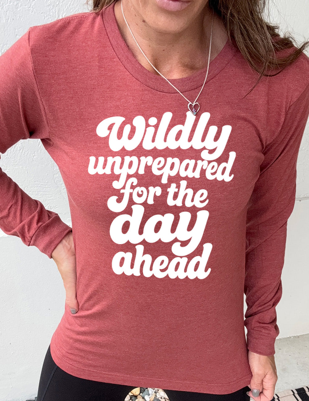 heather clay long sleeve tee with words on it saying "Wildly unprepared for the day ahead"
